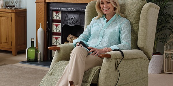 Woman sitting on an Oak Tree rise and recline chair.