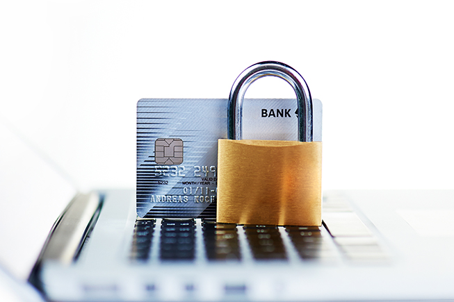 Laptop with a bank card and padlock to represent online safety