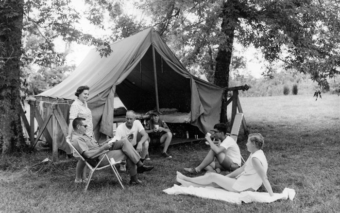 Vintage photo of a family on a camping holiday.