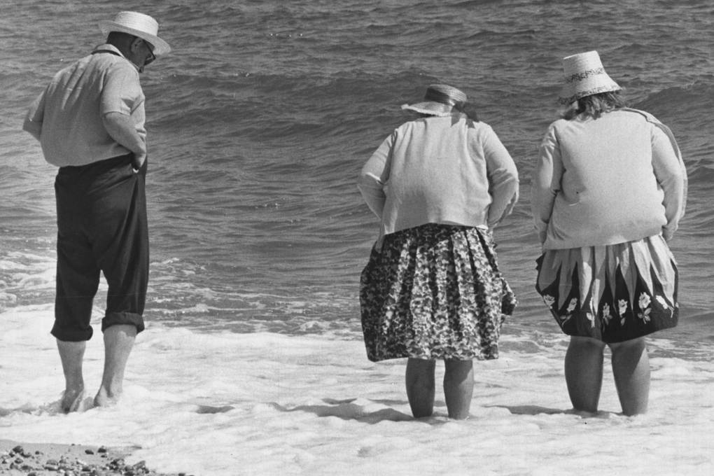 Holidaymakers padding in the sea