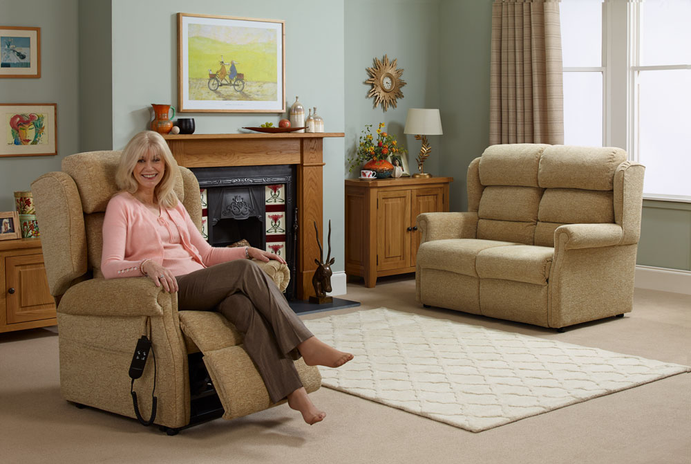 Elderly woman enjoying her rise and recline chair in her living room